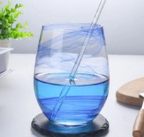 Glass cup with blue print on